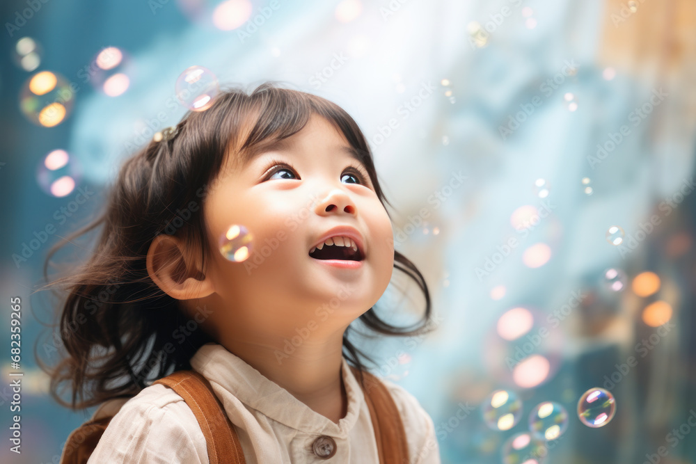 Fototapeta premium Happy asian little girl excited looking up in the bubbles