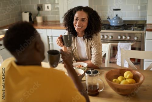 Smiling African woman and her husband talking over coffee at breakfast photo