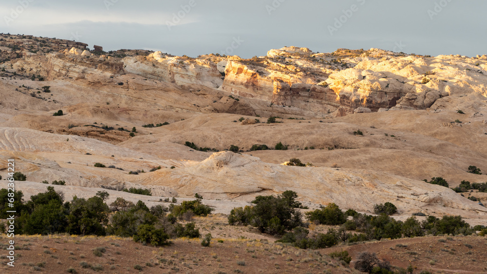 Desert landscape showing eroded rock formations and hoodoos in Utah on a bright sunny day
