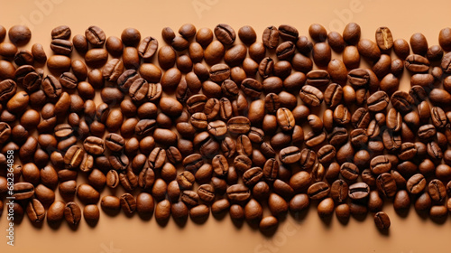 Roasted coffee beans on brown background, Top view with space, can be use as background or texture with sample text © chiew