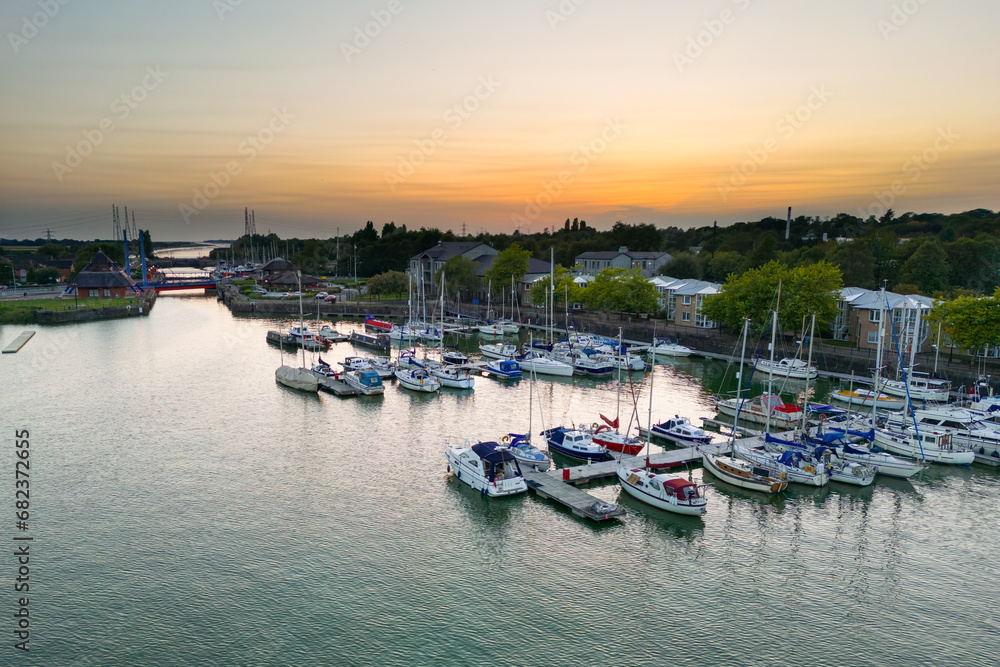Fototapeta premium Preston, Lancashire, UK, September 05, 2023; Aerial Panoramic View of the Re-Developed Docks area and New Marina at sunset in Preston, Lancashire, England