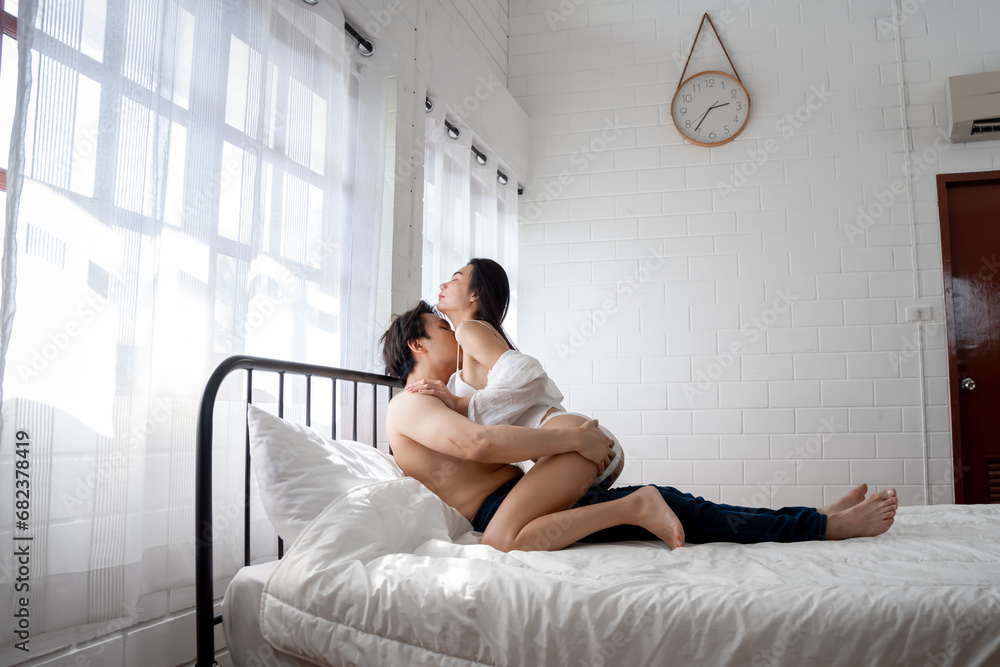 Asian couple, man and woman making love on the bed in the bedroom. Asian couple, man and woman making love on the bed in the bedroom.