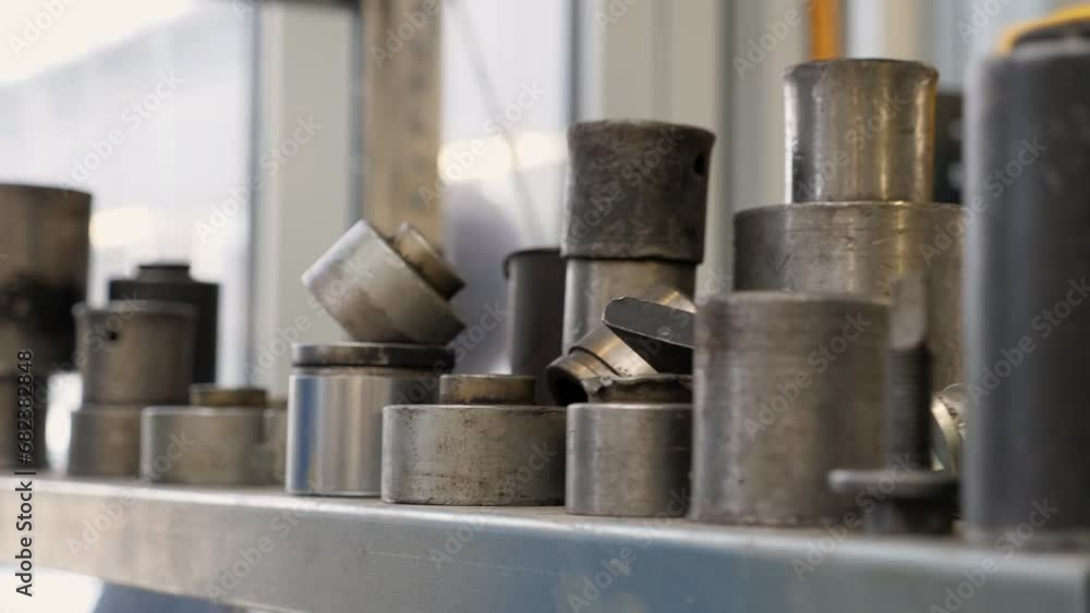 Close-up of a shelf with silent blocks at a car service station, various tools and accessories. Modern auto repair shop. Replacement of the silent block. Stable image. Close-up of a shelf with silent blocks at a car service station, various tools and accessories. Modern auto repair shop. Replacement of the silent block. Stable image.
