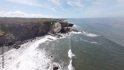 FPV drone flying towards cliffs and the Atlantic Ocean on the beautiful and wild Alentejo Coast in Portugal. Aerial perspective in first person view, POV photo