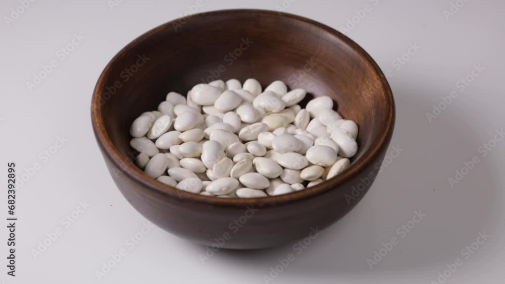 white beans falling in bowl vegan healthy food white beans falling in bowl vegan healthy food