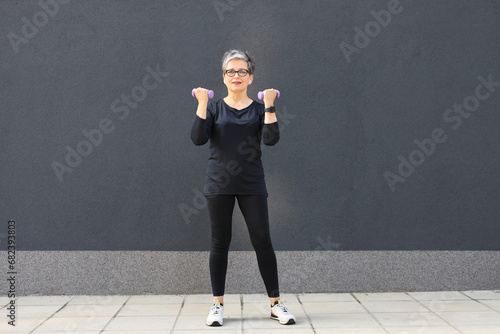 Active woman engages in outdoor fitness, embodying a healthy lifestyle with morning sport. © Andrii Zastrozhnov