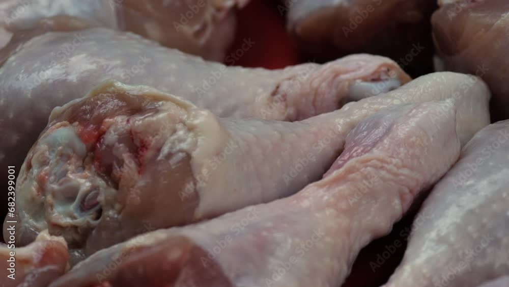 close-up chicken legs raw rotation. concept store for meat products. raw dietary meat, a bunch of chicken legs close-up chicken legs raw rotation. concept store for meat products. raw dietary meat, a bunch of chicken legs
