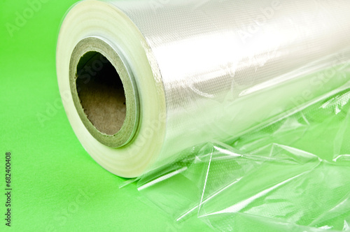 Rolls of wrapping plastic stretch film. Close-up with Shallow Depth of Field. Isolated on green background.