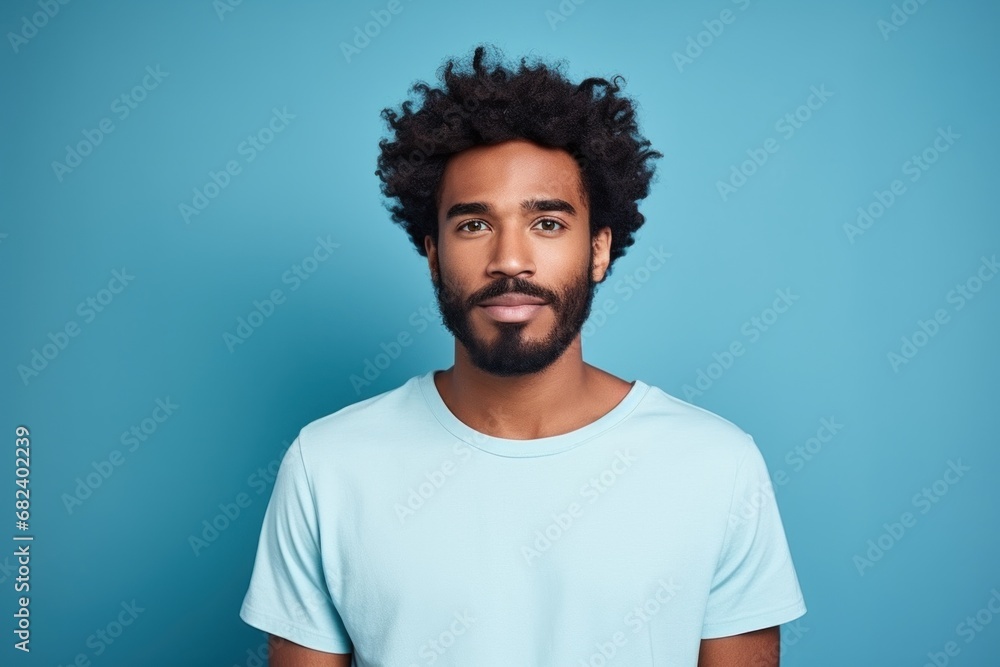 An adorable African American guy donning a T-shirt, perfect for adding text An adorable African American guy donning a T-shirt, perfect for adding text