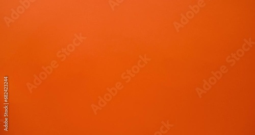 Ringing alarm clock in hand on an orange background. 4K stop motion animation photo