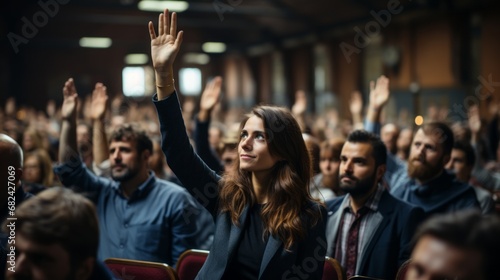 At a professional business seminar, a diverse audience raises their hands in an important decision photo