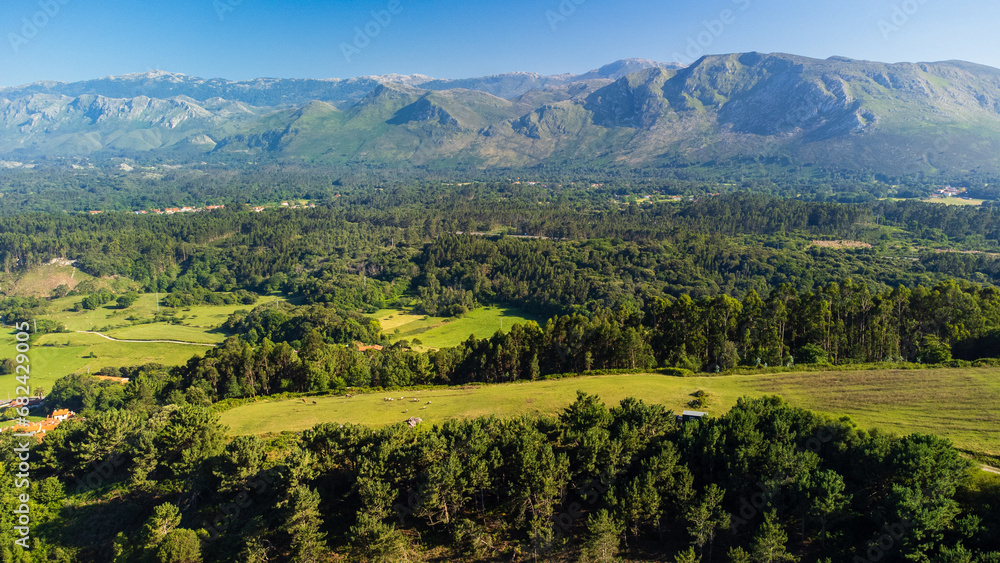 Rural view of green forests, and the Picos de Europa mountains. Asturias, Spain.