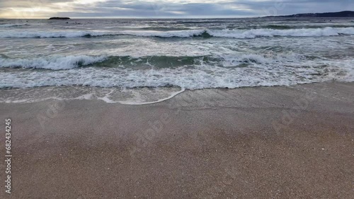 Wallpaper Mural waves roll onto a sandy beach against a background of blue sky with dramatic thunderclouds, sunset, beautiful landscape, slow motion Torontodigital.ca