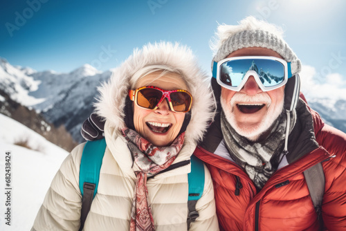 Happy elderly couple skiing in the Alps mountains. Senior man and woman enjoying ski vacation in alpine resort. Active retirement. Healthy winter sport for every age.