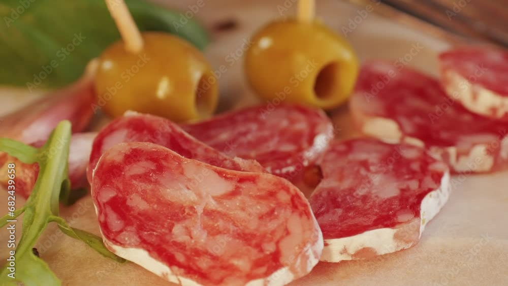 Mix of spanish pork sausages, Cutting board of appetizing catalonian snack - fuet, jamon, chorizo, olives, supermarket tapas food in spain, traditional cuisine. Mix of spanish pork sausages, Cutting board of appetizing catalonian snack - fuet, jamon, chorizo, olives, supermarket tapas food in spain, traditional cuisine.