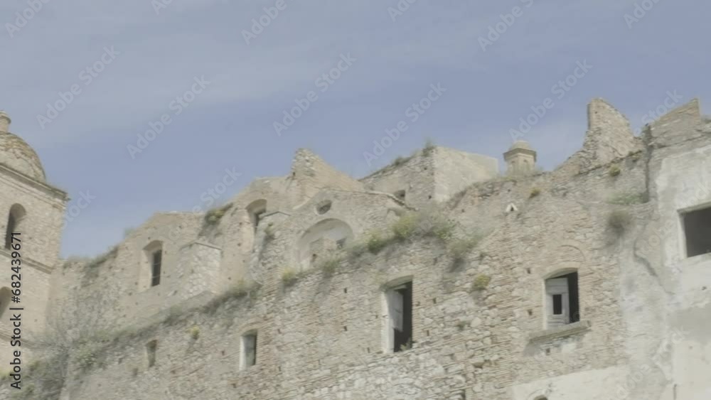 CRACO, ITALY - MAY 2, 2023: panning shot, the ruined walls and windows of some houses of the abandoned town, detail.
CRACO, ITALY - MAY 2, 2023: panning shot, the ruined walls and windows of some houses of the abandoned town, detail.