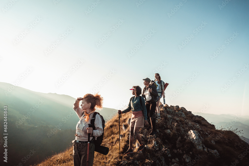 © Marko Geber - Friends Group Hike to Mountain Summit at Sunset © Marko Geber - Friends Group Hike to Mountain Summit at Sunset