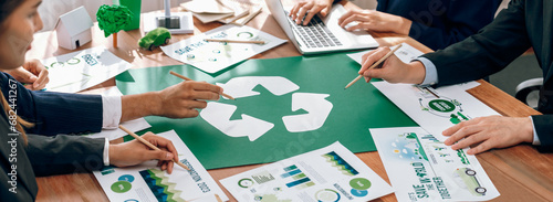 Group of business people planning and discussing on recycle reduce reuse policy symbol in office meeting room. Green business company with eco-friendly waste management regulation concept.Trailblazing photo