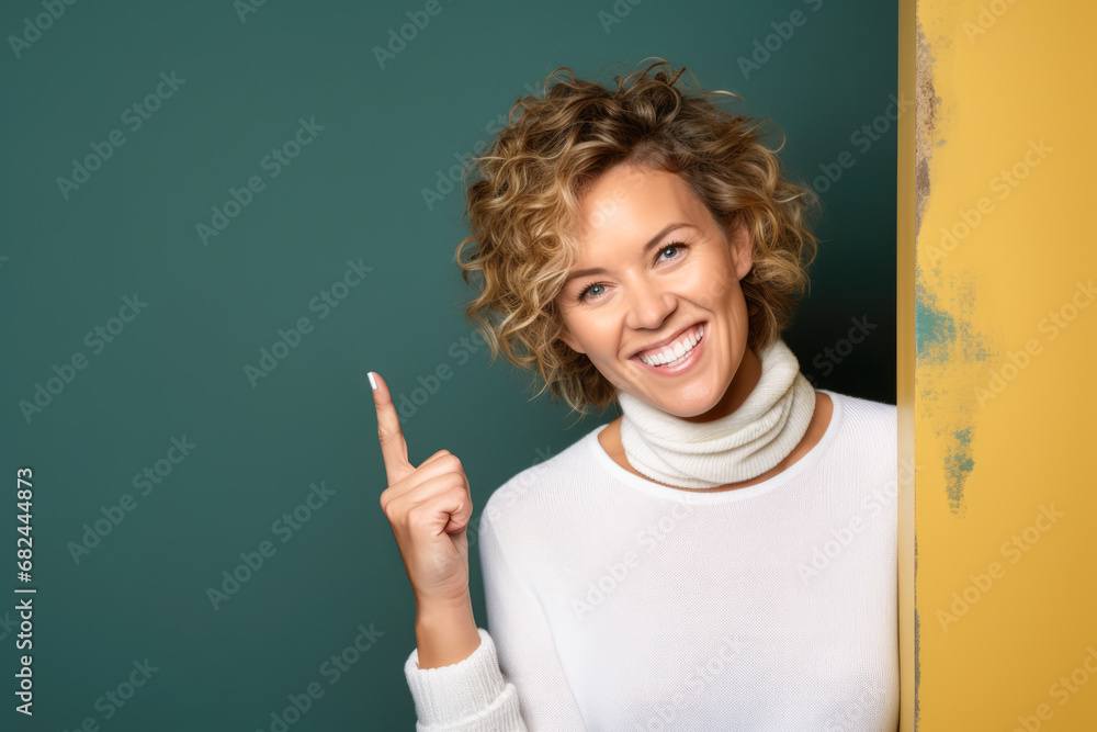 A woman pointing at something on a background of green. A woman pointing at something on a background of green.
