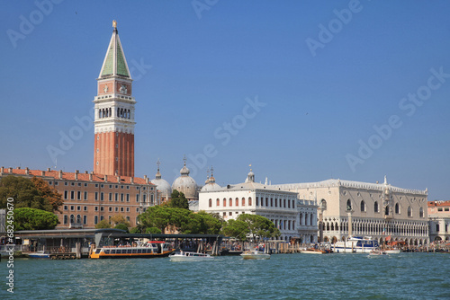 venice view from the canale grande to the marble tower and doge's palace with boats against a blue sky 