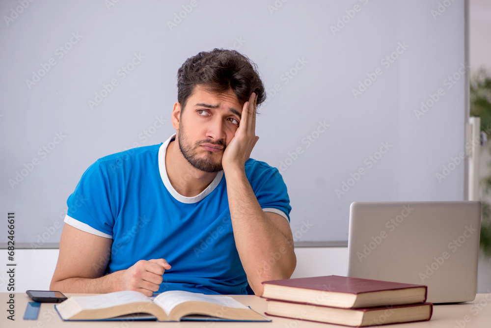 Young male student in front of whiteboard Young male student in front of whiteboard