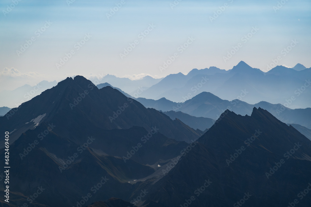 Silhouettes of Italian Alps mountain ridges in summer