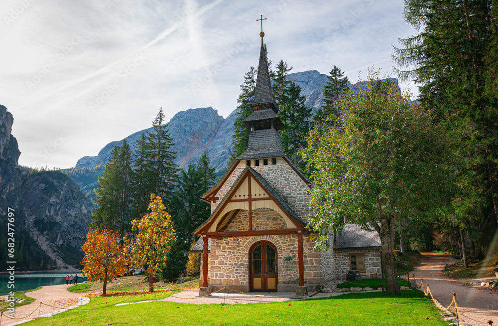 Scenic chapel or little church on the shore of famous Braies Lake in the Dolomite Mountains