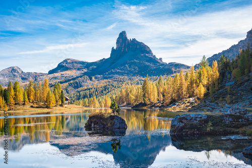Iconic rock mountain´Becco di Mezzodi´ surrounded by golden larch trees near Lake ´Lago Federa´ in the Dolomite mountains, Italy