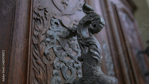 Beautiful ancient door filled with adornment, doorknob and ornamentation. Aesthetic antique traditional craftsmanship
