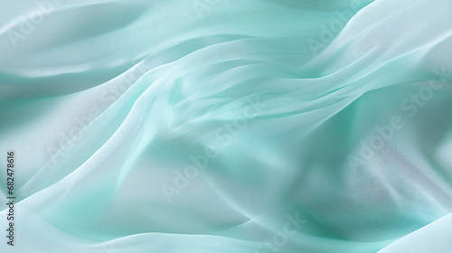 Diagonal folds of lustrous turquoise and white fabric glimmer in the sunshine, presenting a seamless texture.