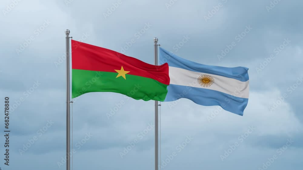 Argentina flag and Burkina Faso flag waving together on cloudy sky, endless seamless loop, two country relations concept Argentina flag and Burkina Faso flag waving together on cloudy sky, endless seamless loop, two country relations concept
