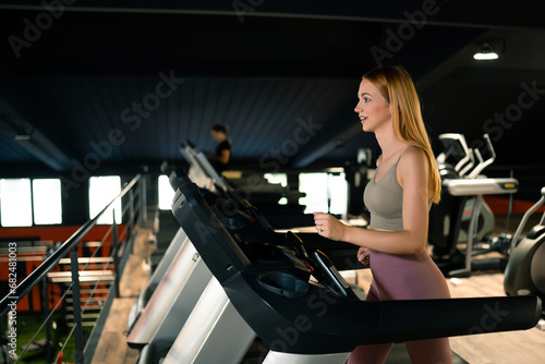 Sporty woman exercising in fitness gym.