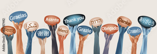 Raised hands of multicultural people from different nations and continents holding speech bubbles with text THANK YOU in various international languages.Communication. Equality. Inclusion