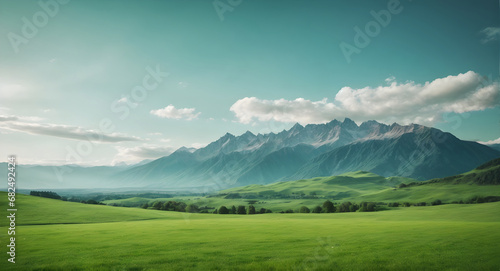 beautiful green meadow and mountains in background with blue sky