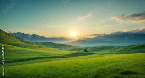 beautiful green meadow and mountains in background with blue sky with sunrise