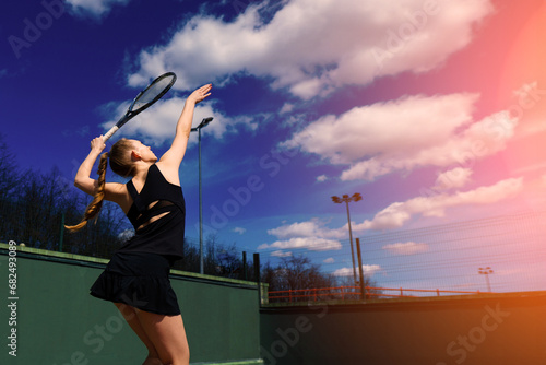 Happy beautiful sexy girl playing tennis on the court. Sport and recreation, leisure photo