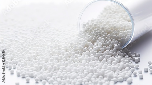 White plastic, polymer pellets for the production of plastic products. Close-up, isolated on a white background photo