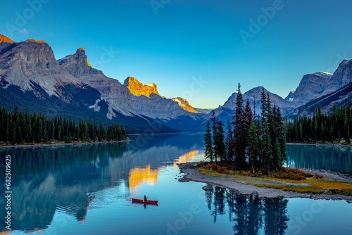 a tranquil mountain lake, surrounded by majestic snow-capped mountains, Morine lake Canada © Wirestock