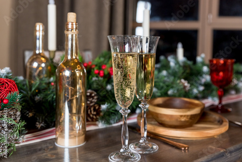 glasses for champagne  Christmas time decorations  New Year dinner  luxury home interior.Champagne and new year decor. cozy home  ready for winter holidays