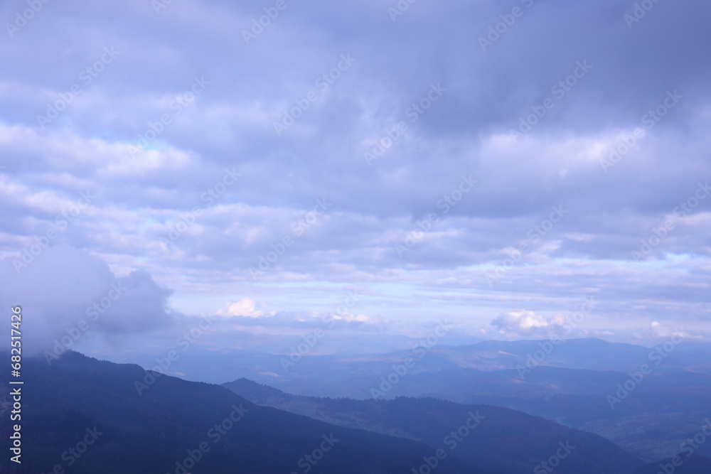 Morning view from the Dragobrat mountain peaks in Carpathian mountains, Ukraine. Cloudy and foggy landscape around Drahobrat Peaks in early morning Morning view from the Dragobrat mountain peaks in Carpathian mountains, Ukraine. Cloudy and foggy landscape around Drahobrat Peaks in early morning