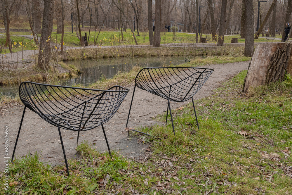 Kharkiv, Ukraine. - November 11, 2023: metal chairs are placed in Sarzhyn Yar Park so that people can sit and look at the park Kharkiv, Ukraine. - November 11, 2023: metal chairs are placed in Sarzhyn Yar Park so that people can sit and look at the park