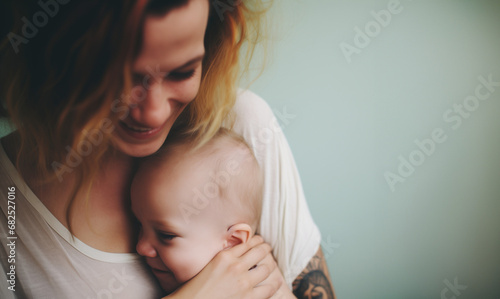 A mother's comforting embrace envelopes her baby, with the child's face pressed against her in a serene and loving moment.