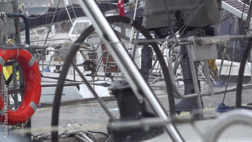 Rain in the winter marina. Metal pipes of sailing yachts. Slow motion.