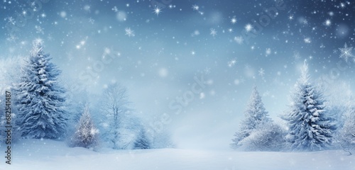 The abstract blue background, adorned with snow, creates a serene and festive winter wonderland.
