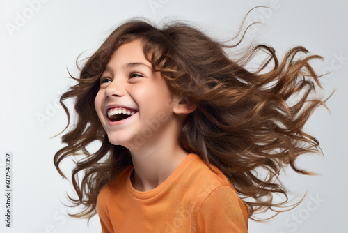Young girl with long brown hair smiles warmly. This picture can be used to portray happiness, joy, and positivity. It is suitable for various projects and designs photo