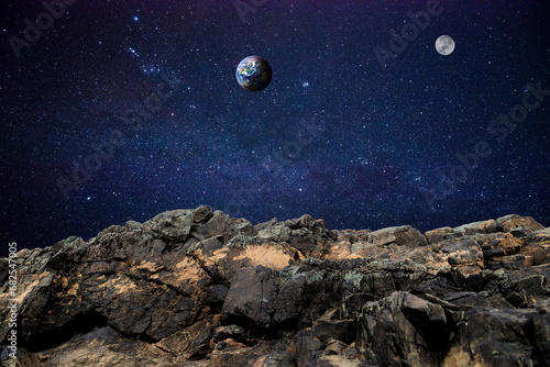 rock in space over earth and moon