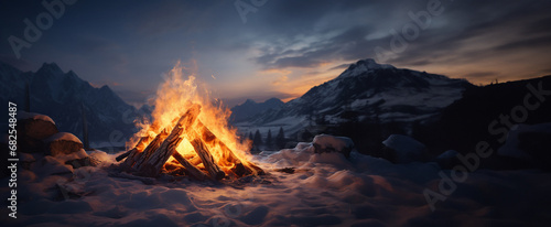 Campfire in the winter forest. Beautiful landscape of nature and trees. Sparks and flames