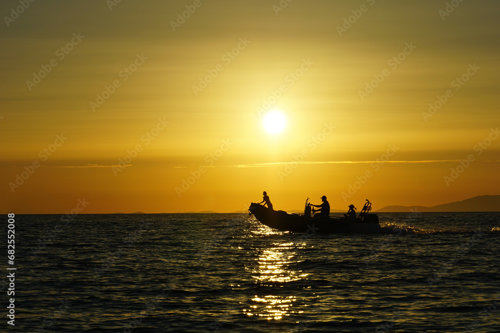 Water activities concept with silhouette of motor boat driving on the sea