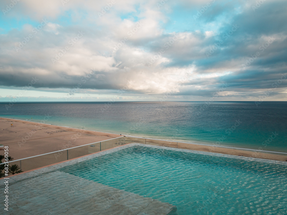 Aerial view of an infinity pool and the sea