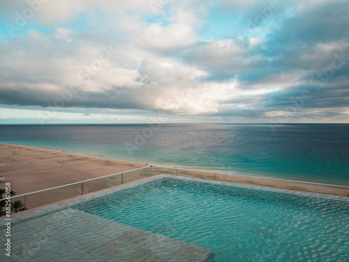 Aerial view of an infinity pool and the sea © arianarama